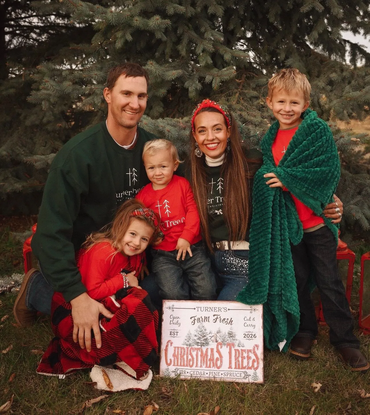 The Turner family with their Farm Fresh Christmas Trees sign